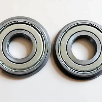 Two Canon IR5075 LOWER BERING metal ball bearings, each with a central hole, identical circular shapes, and a smooth metallic finish, are placed side by side on a white surface.