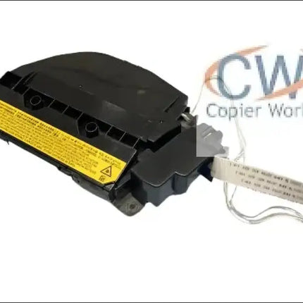 A black car airbag module with a yellow warning label and attached wiring harness is displayed on a white background, similar to the meticulous re-conditioning done by Copier World for the kyocera 2040 laser unit.